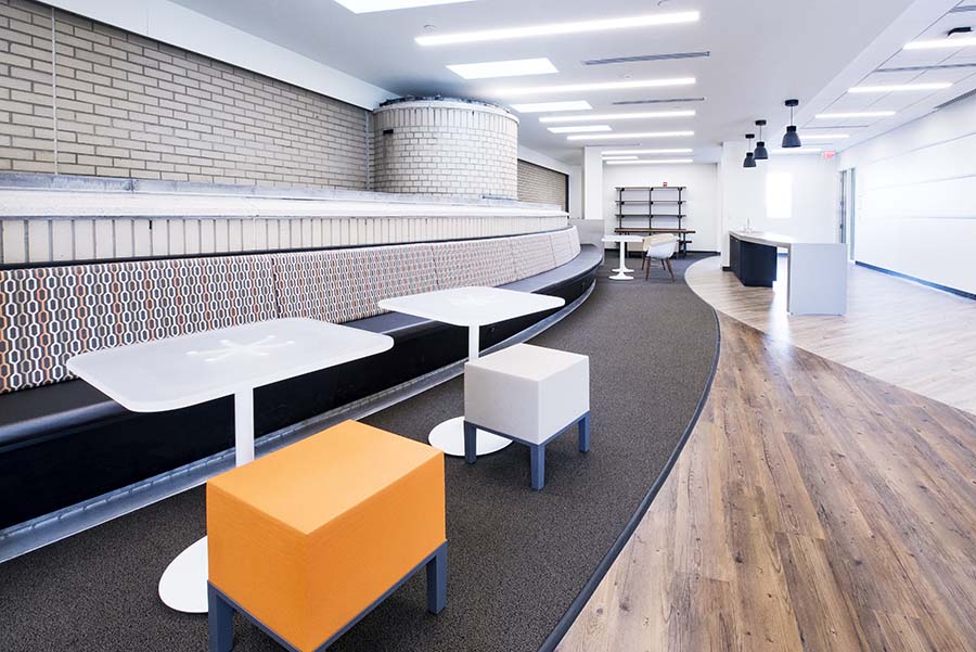 Photo of the Graduate Student Lounge featuring a booth and tables